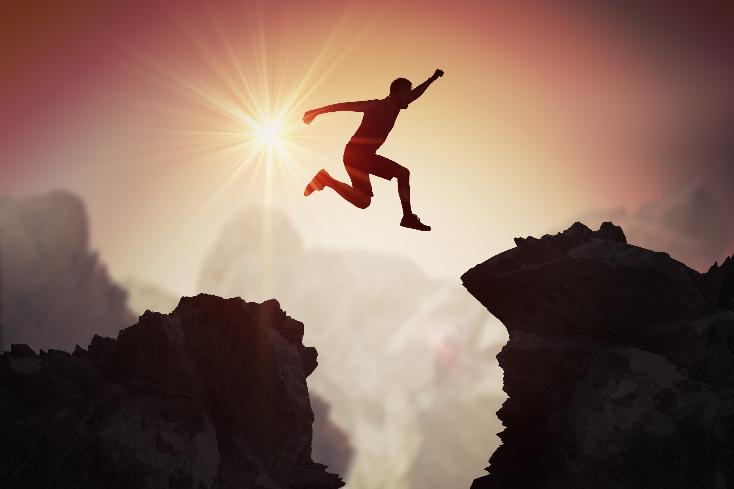 Silhouette of young man jumping over mountains and cliffs at sunset. Silhouette of young man jumping over mountains and cliffs at sunset.