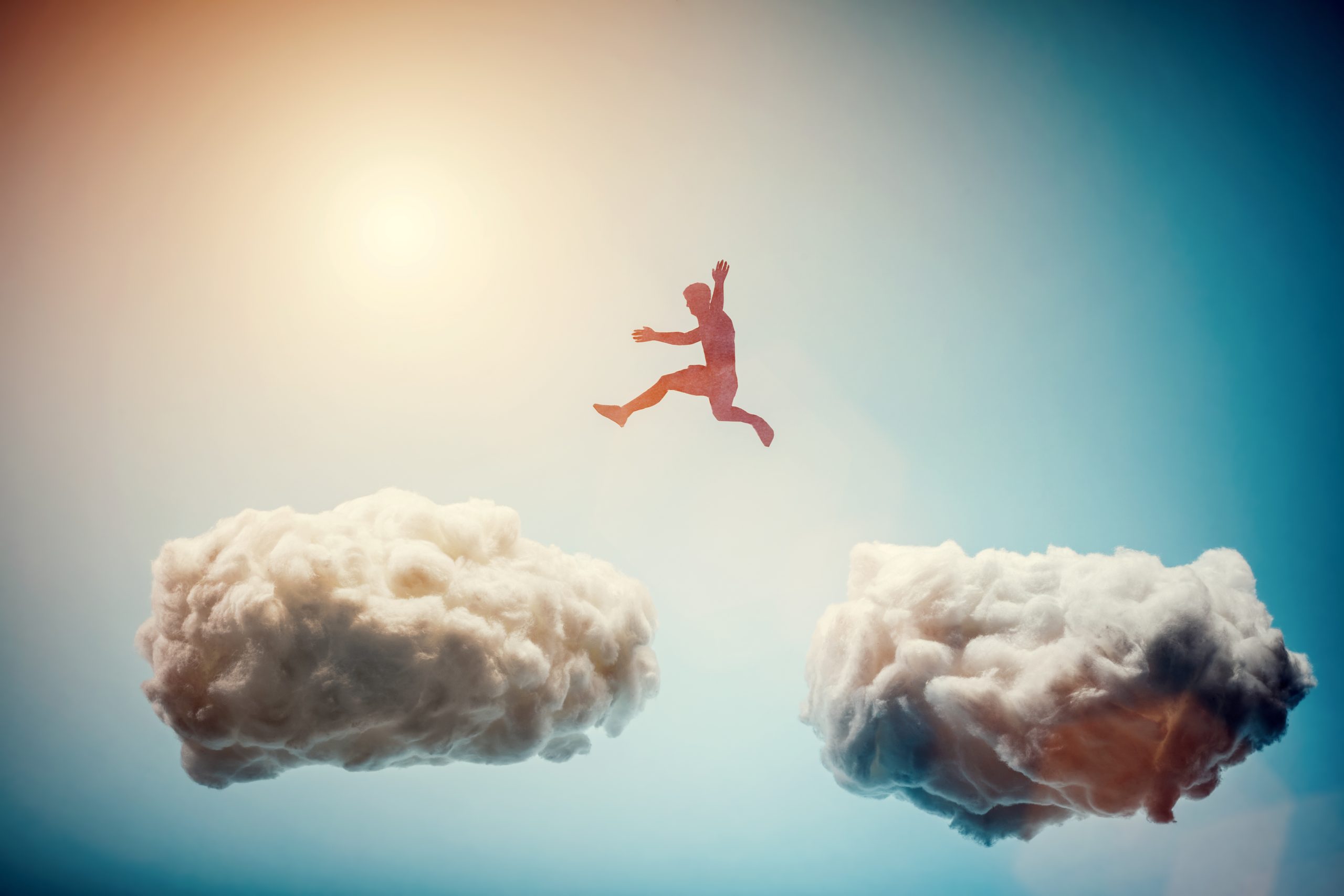 Man jumping from one cloud to another. Taking risks and challenge concept. Overcoming problems, winning.