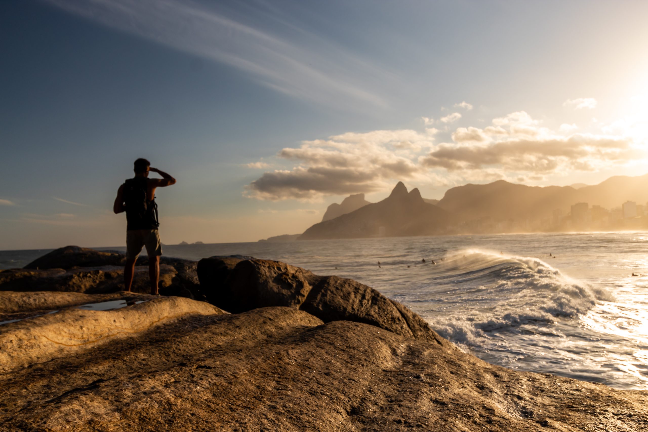 man looking at the Sunset on the Arpoador stone, Arpoador beach in Rio de Janeiro, Brazil man looking at the Sunset on the Arpoador stone, Arpoador beach in Rio de Janeiro, Brazil