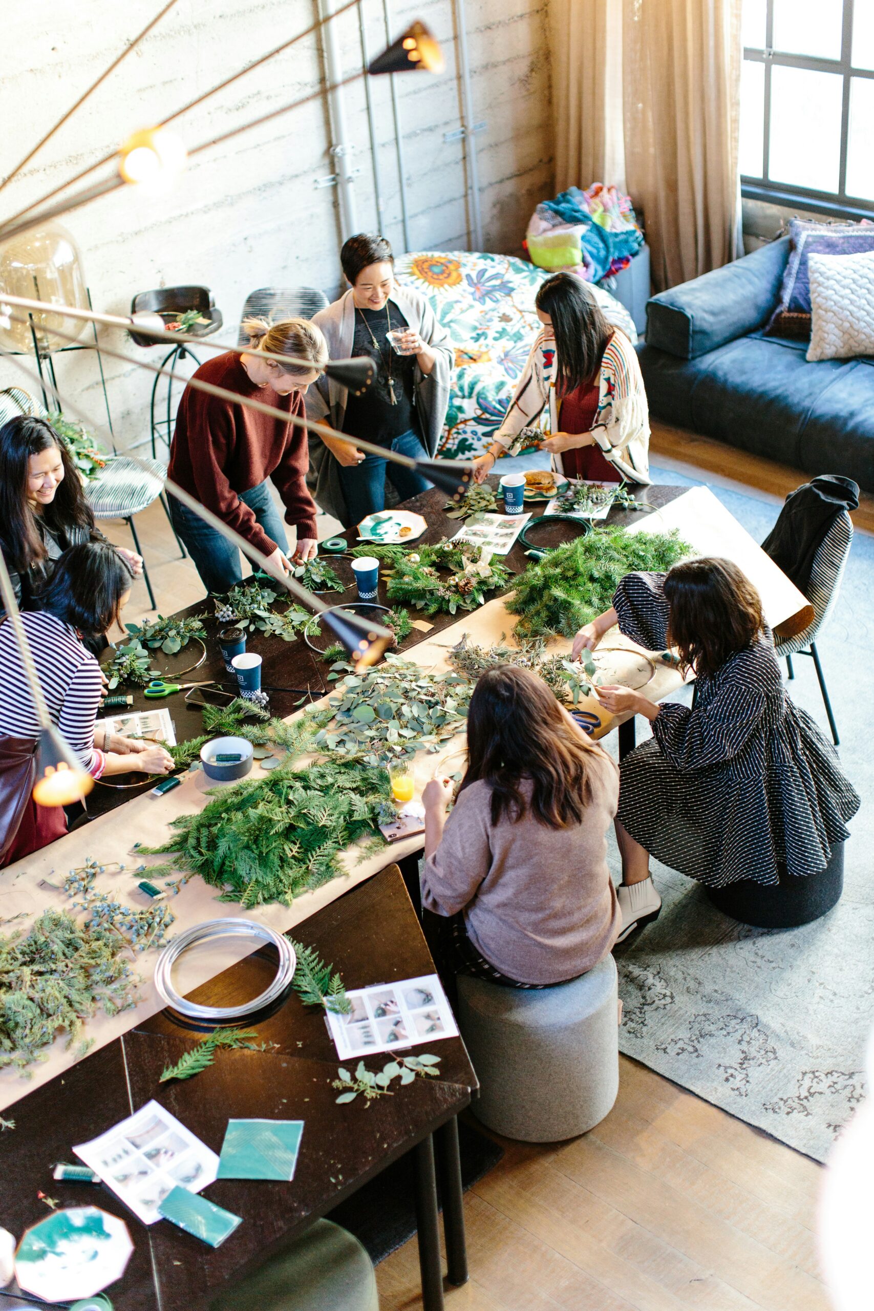 group of people around a table with leaves on the table