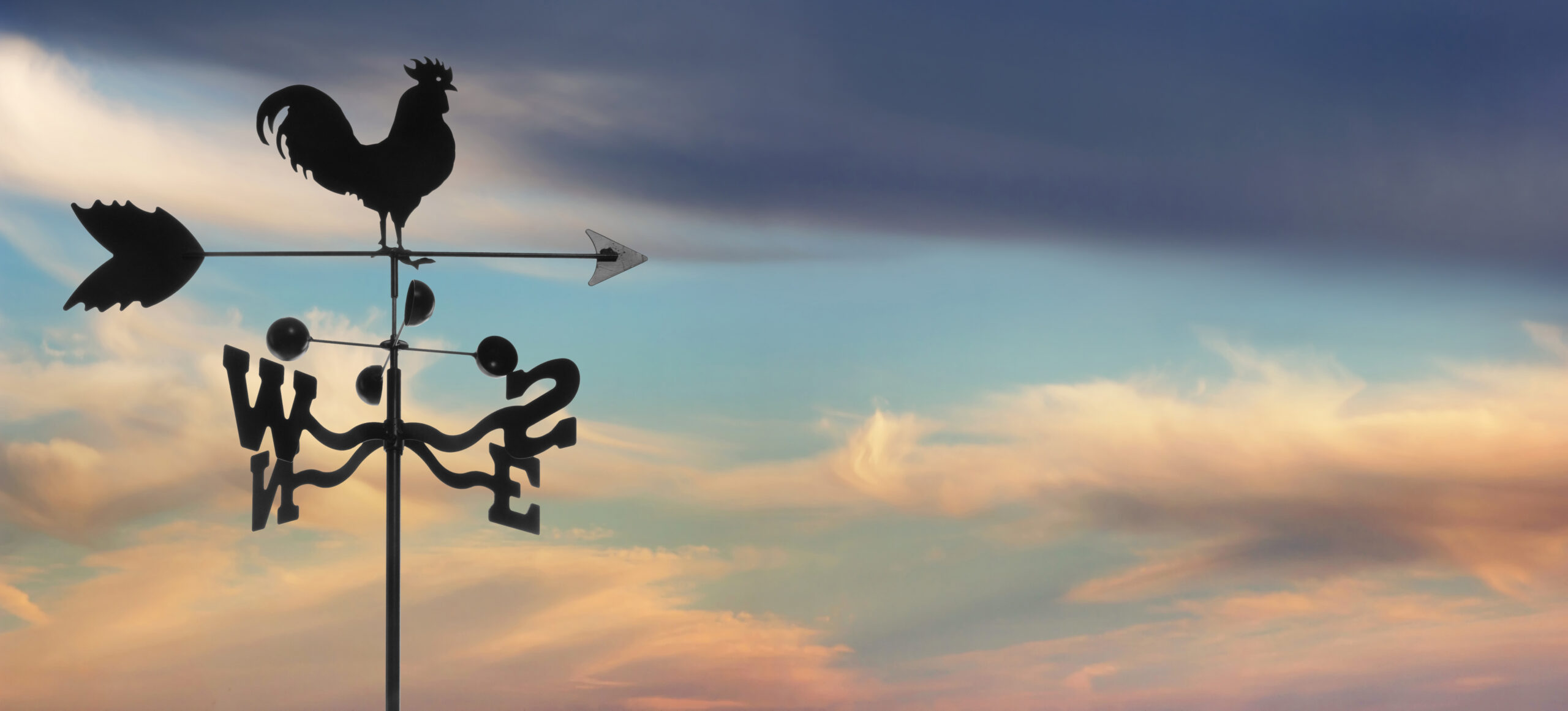 iron weathervane against horizontal cloudscape