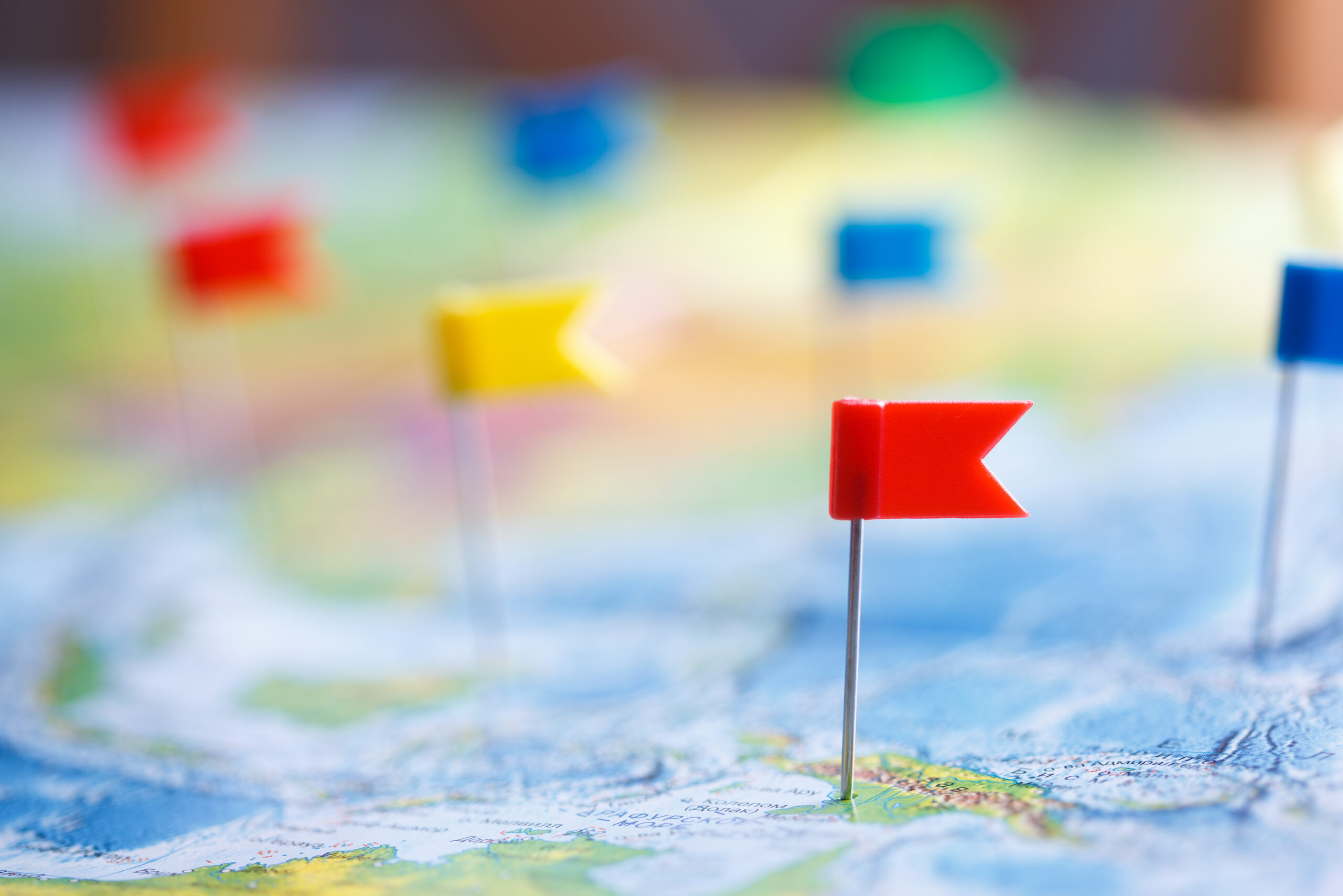 Macro photo with flag pushpins and world map.Travel concept Macro photo with flag pushpins and world map.Travel concept.