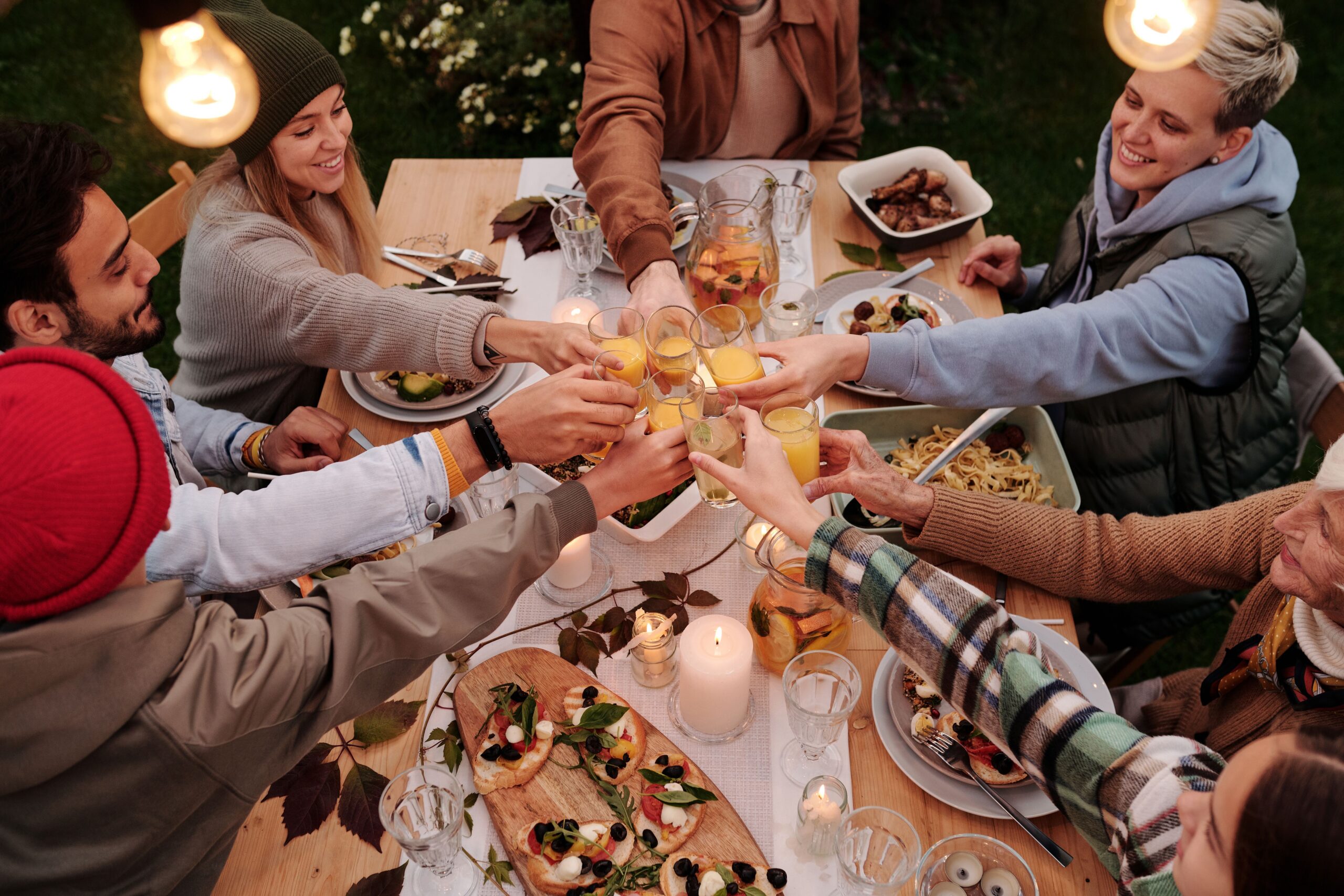 pexels-askar-abayev-5638751 happy people cheersing at dinner