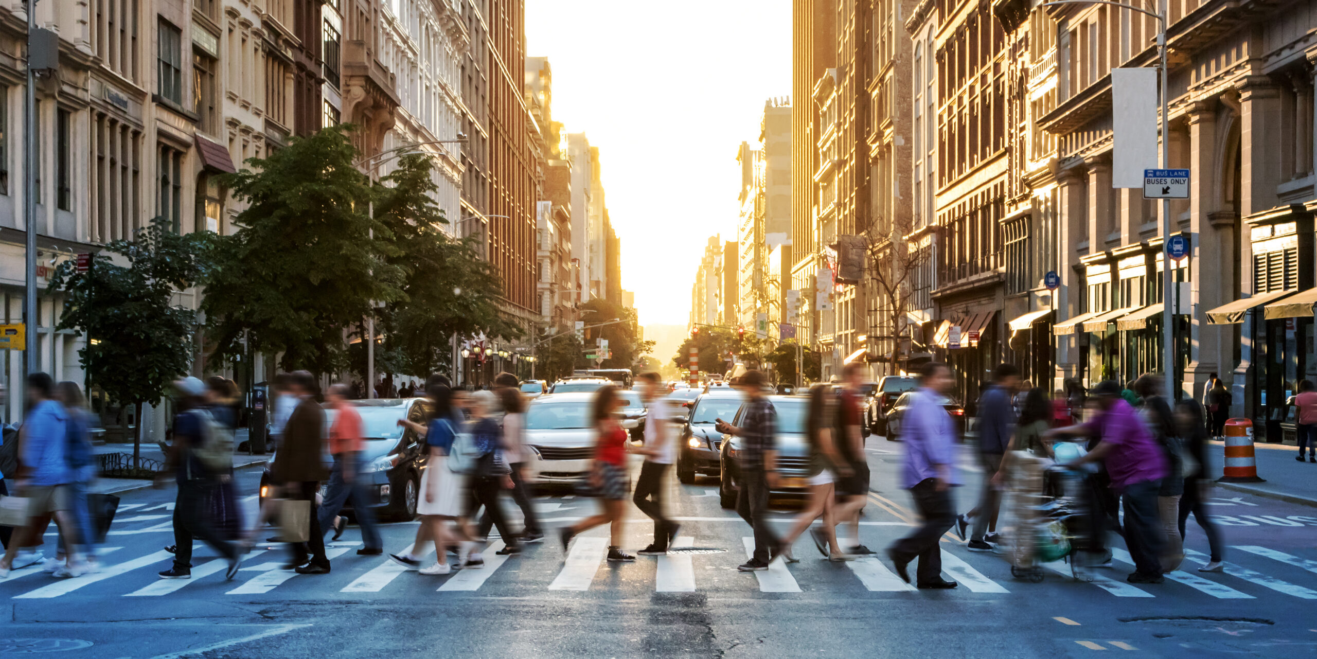 Crowds of people walking across a busy crosswalk at the intersec Crowds of people walking across a busy crosswalk at the intersection of 23rd Street and 5th Avenue in Manhattan New York City NYC