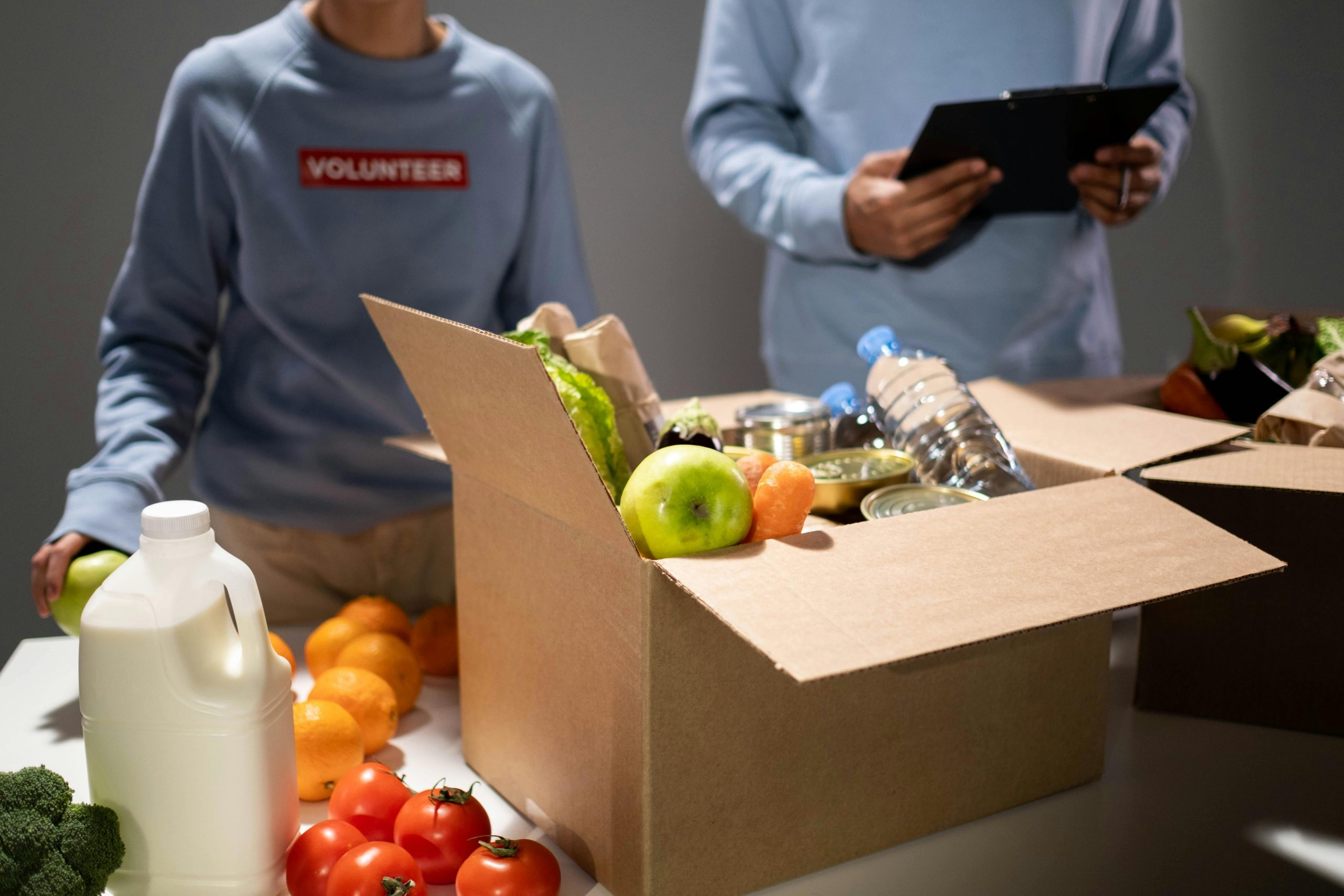 volunteers with a box of food