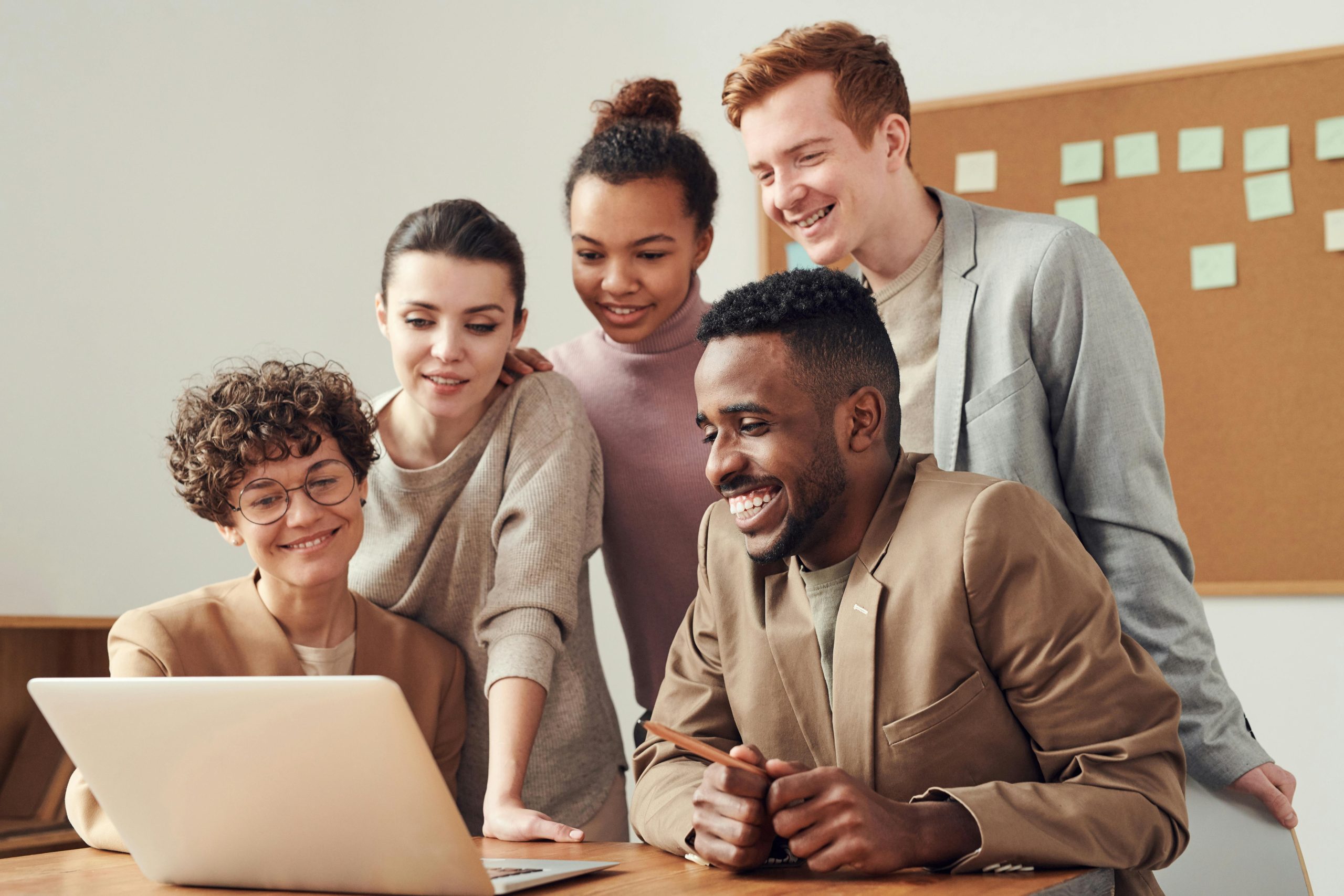 pexels-fauxels-3182812 happy office people around a laptop