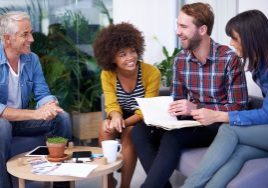 Shot of a group of happy coworkers in a meeting.
