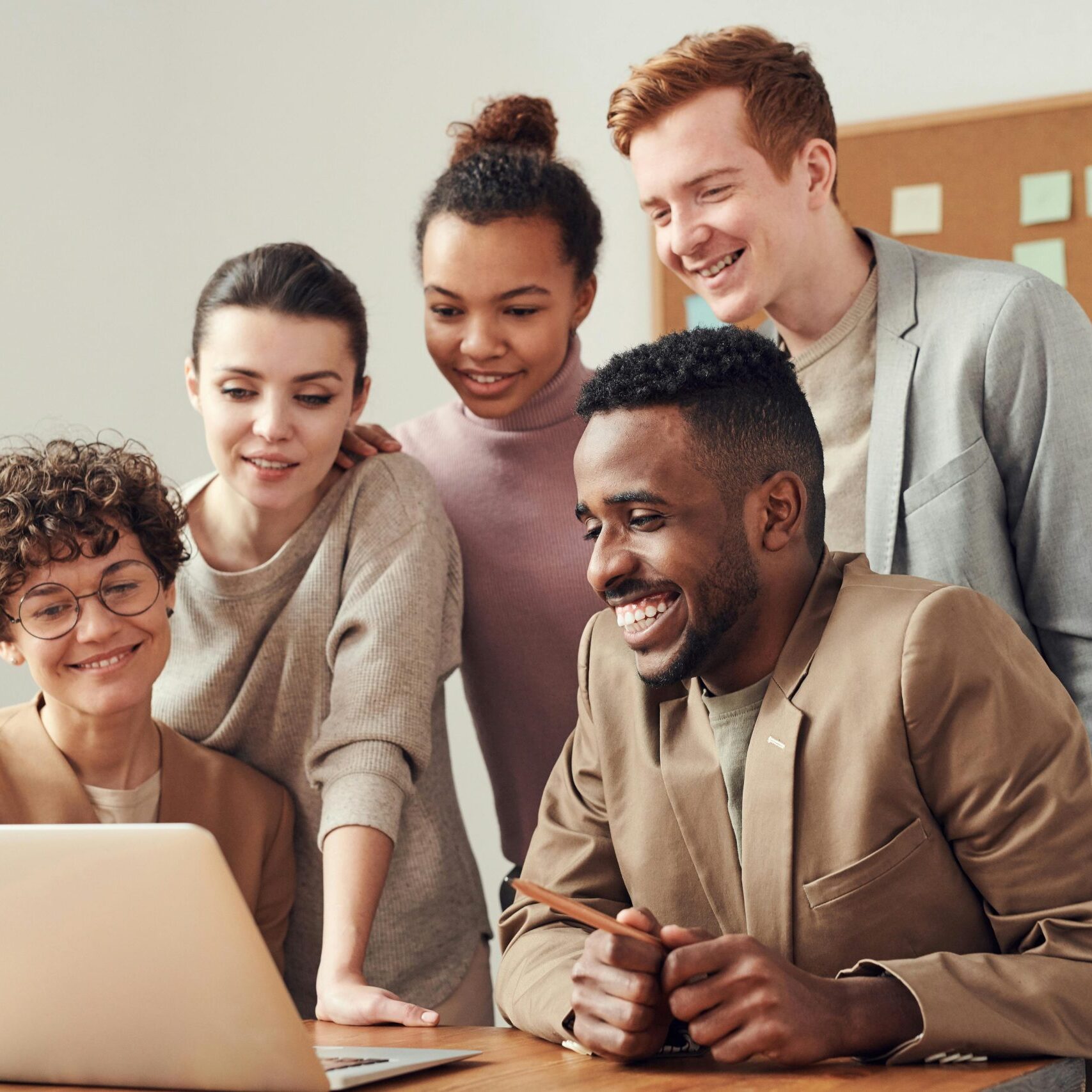 pexels-fauxels-3182812 happy office people around a laptop